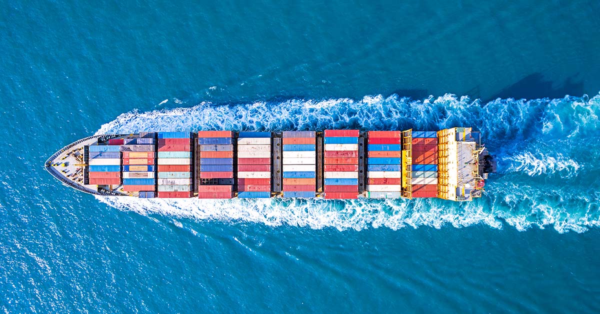 photograph of shipping container in the sea from above