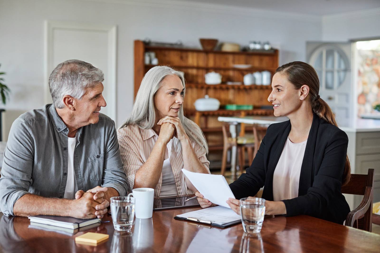 An adviser meeting with a middle-aged couple in their home