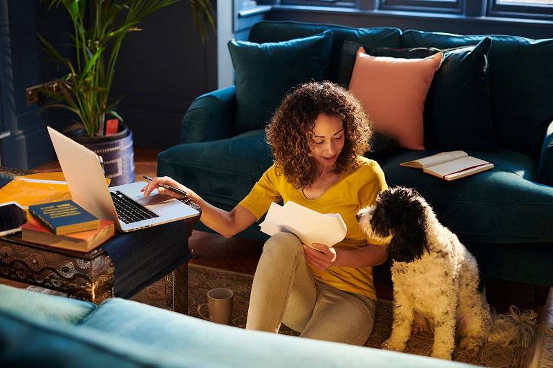 Grandfather with grandson on his shoulders walking through a field