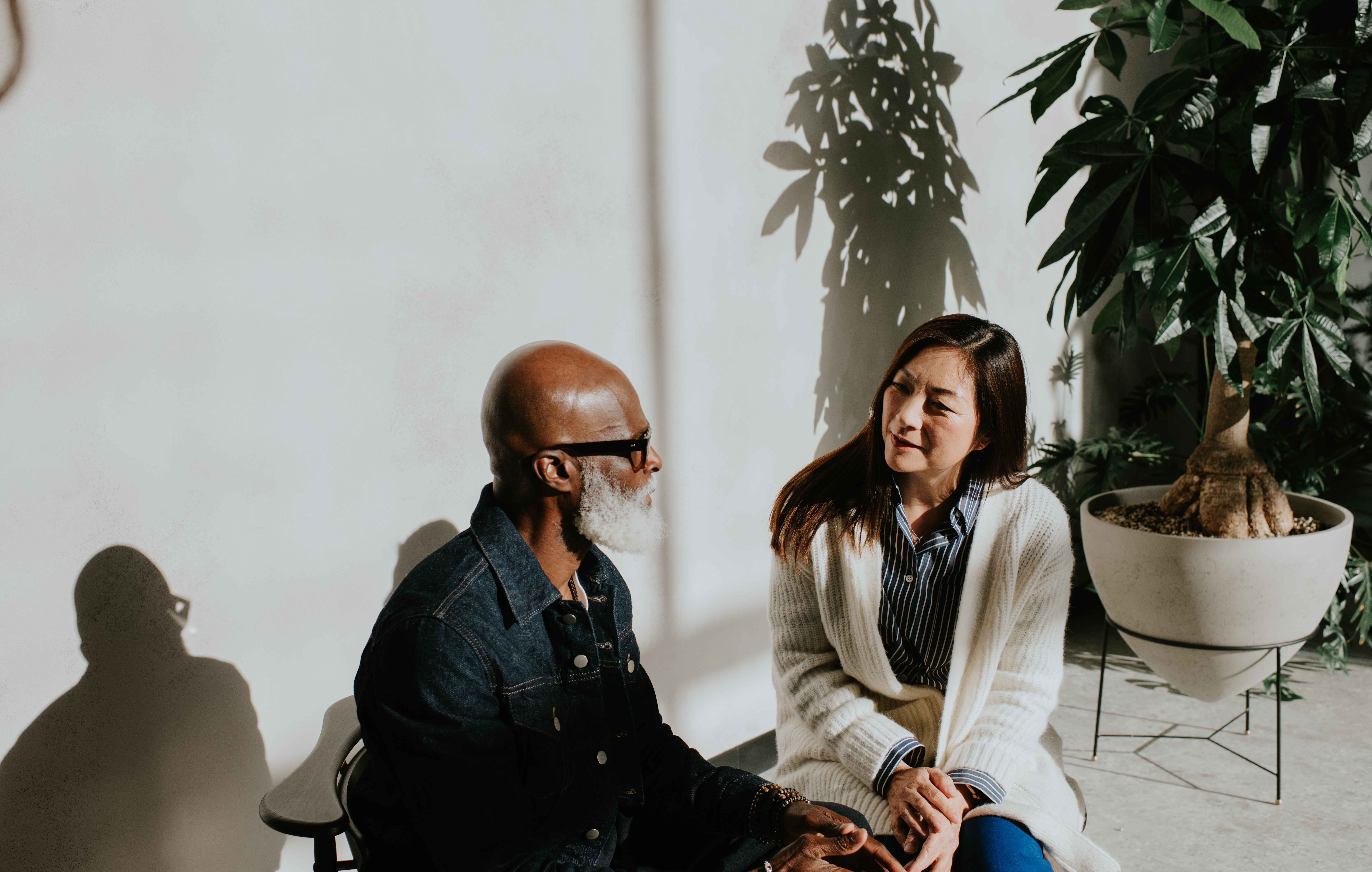 Two people talking in a sunny porch