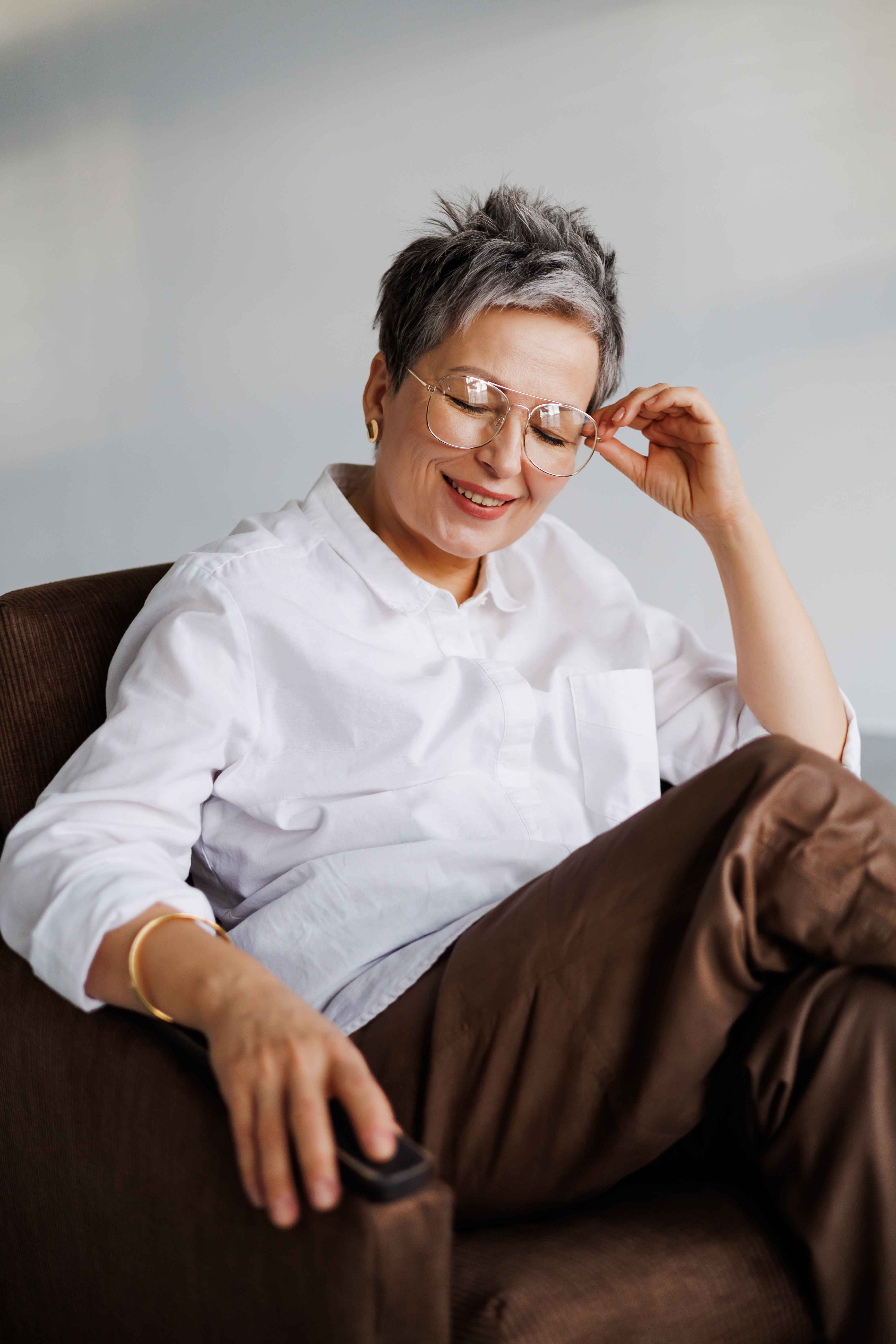 A lady sits in a chair and takes a moment to relax