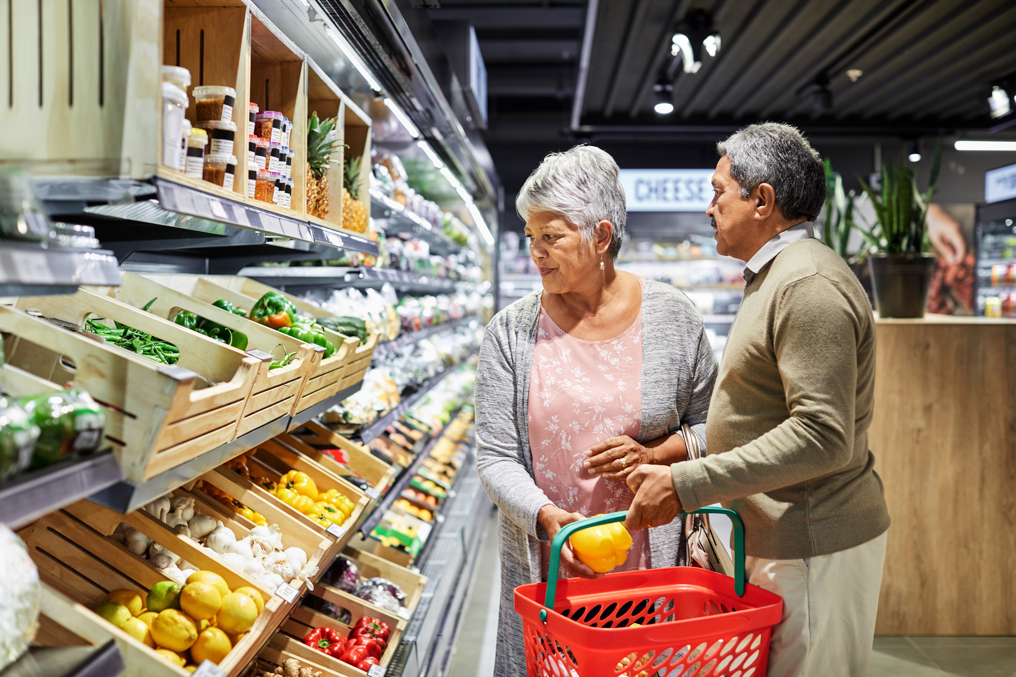 Couple in fruit aisle in supermarket