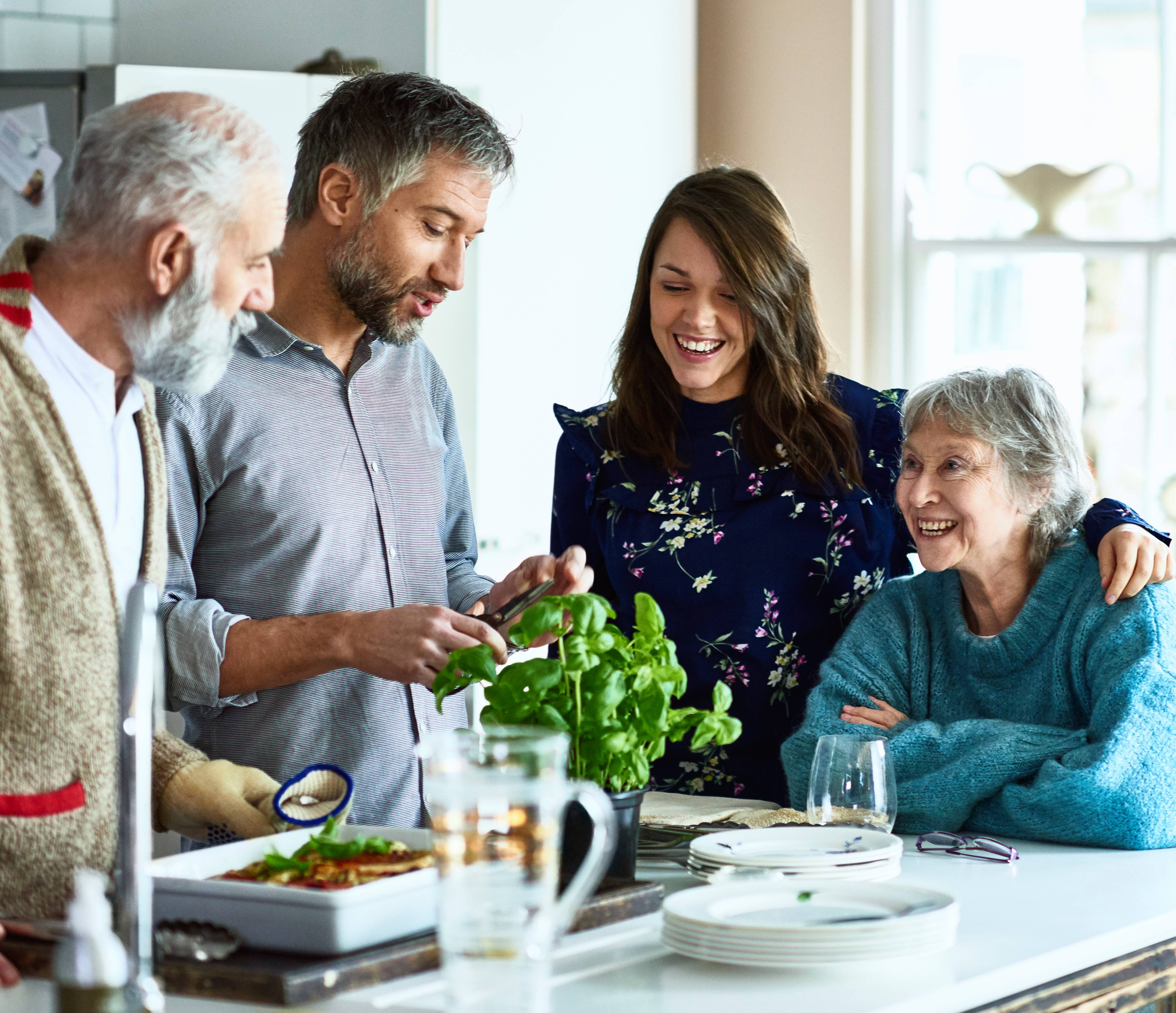 Multi-generational family laughing in the kitchen