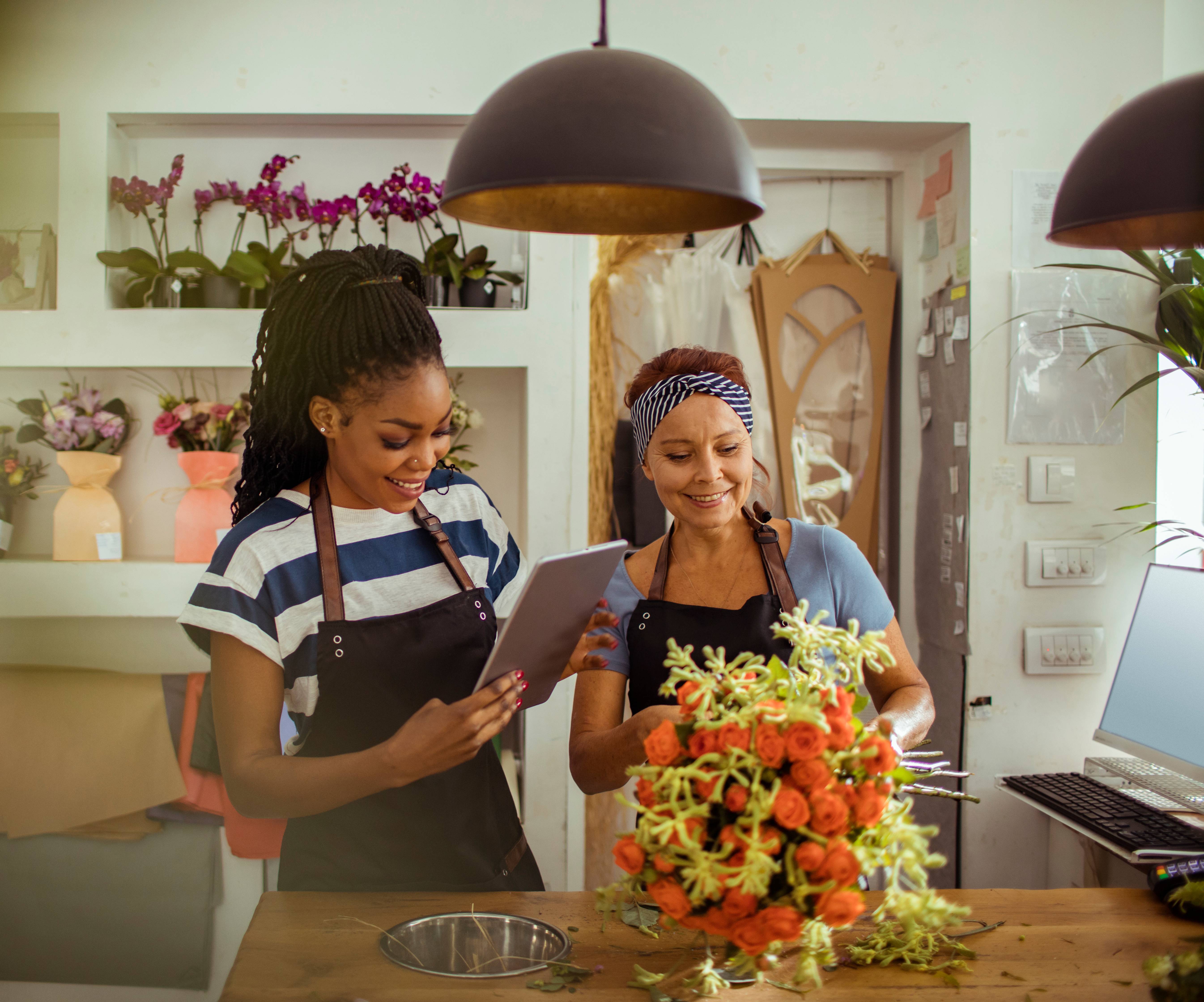A younger and older woman working in a flower shop
