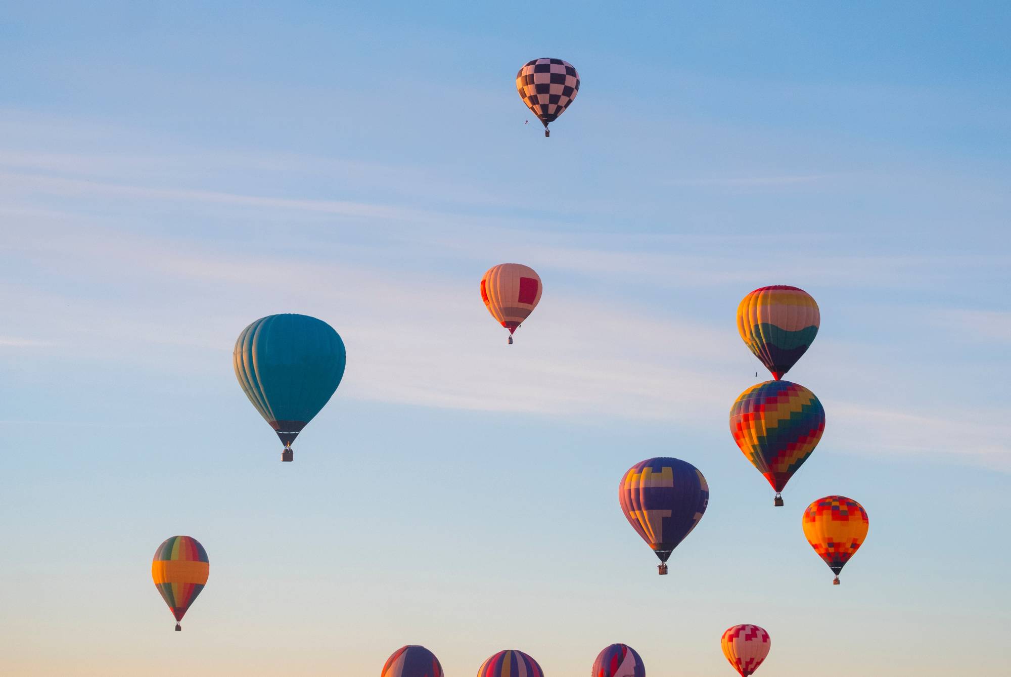 Hot air balloons rise up into the sky together