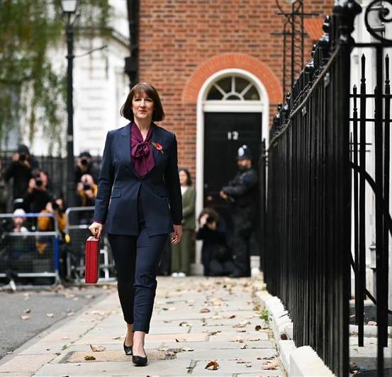 Rachel Reeves walks past eleven Downing Street with the red Budget box