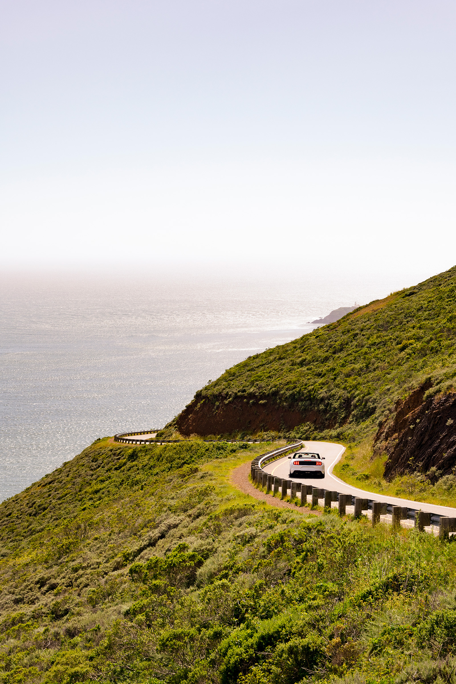 Car driving along coast of California