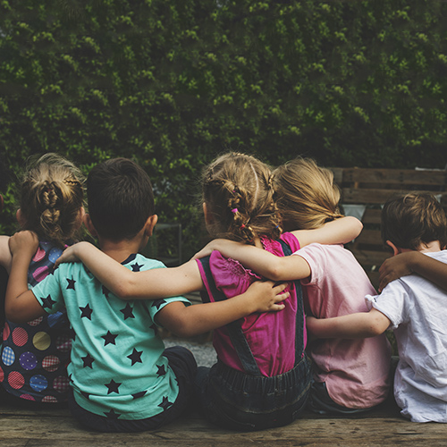 A group of children hugging together