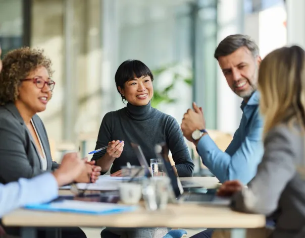 People sat around a table talking