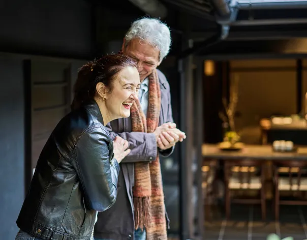 Grandfather and daughter walking and laughing