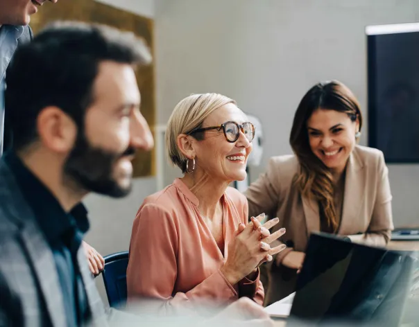 A group of colleagues smiling and chatting
