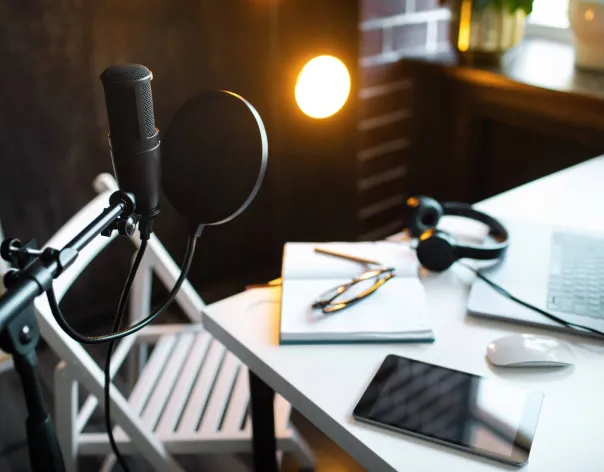 A microphone and recording equipment in a podcast studio 