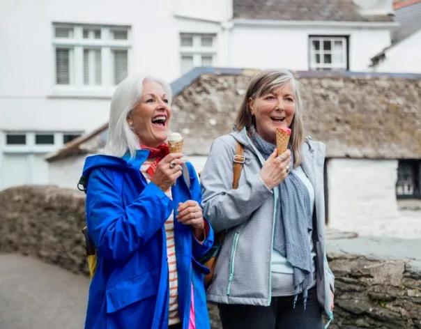 Two women enjoying ice cream on a relaxed day out, representing the freedom and confidence that comes from effective financial planning