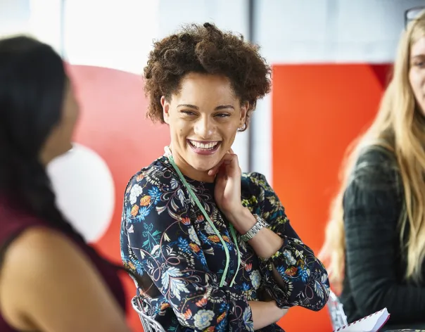 Three charity trustees talking about the role of investment governance at an event