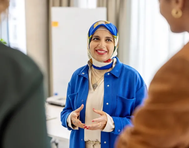 Three charity trustees talking in a group about the importance of investment governance within charities