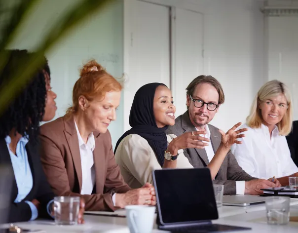 Group of people discussing year end planning in meeting
