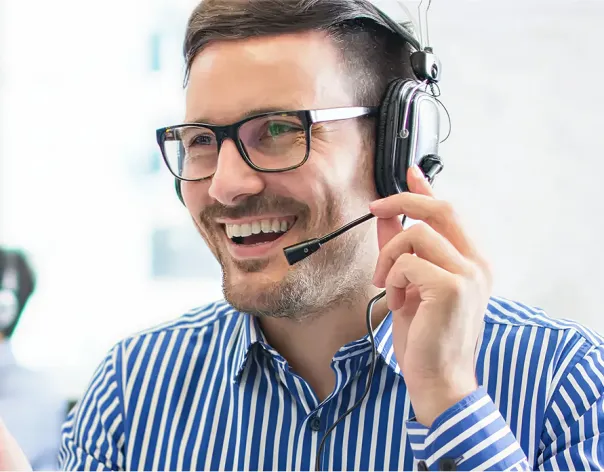 A MyRathbones support team member speaks to a client over the phone while wearing a headset
