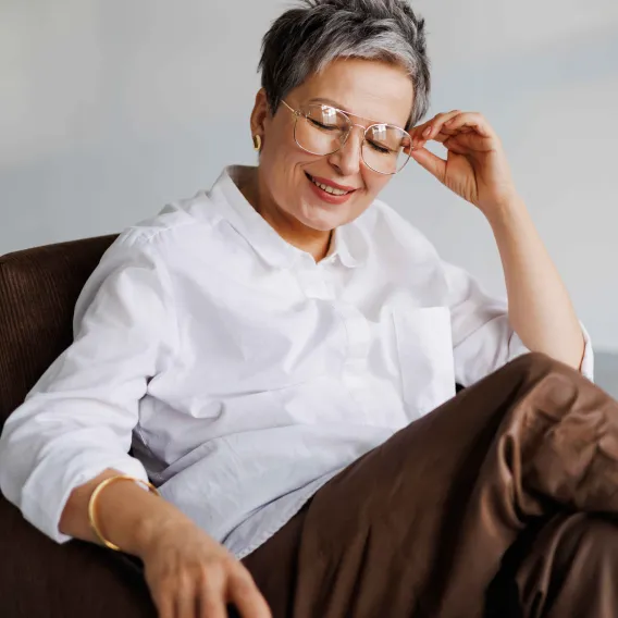 A lady sits in a chair and takes a moment to relax