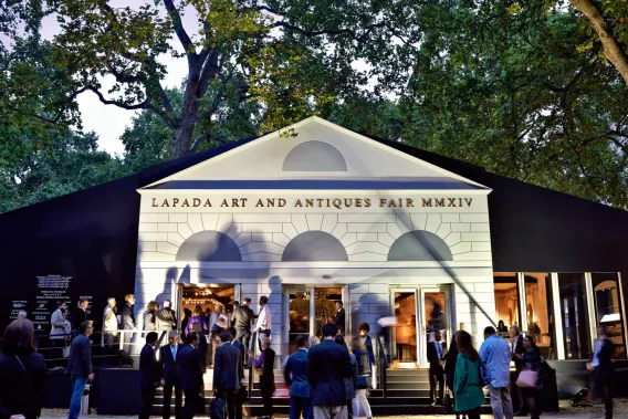 Art fans mill around the front of the LAPADA Art and Antiques Fair marquee in Mayfair