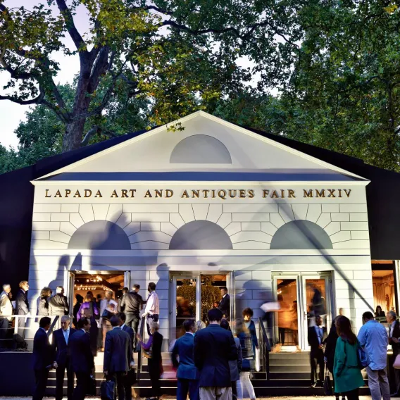 Art fans mill around the front of the LAPADA Art and Antiques Fair marquee in Mayfair
