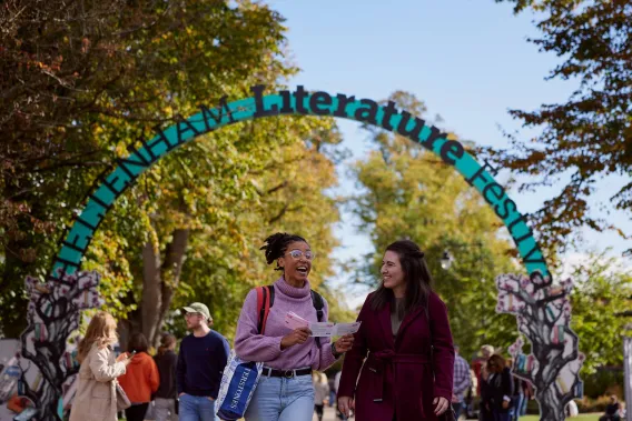 Two attendees of the Cheltenham Literature Festival walk and talk
