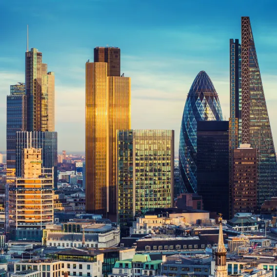 The sun rises on the skyscrapers of the City of London's square mile
