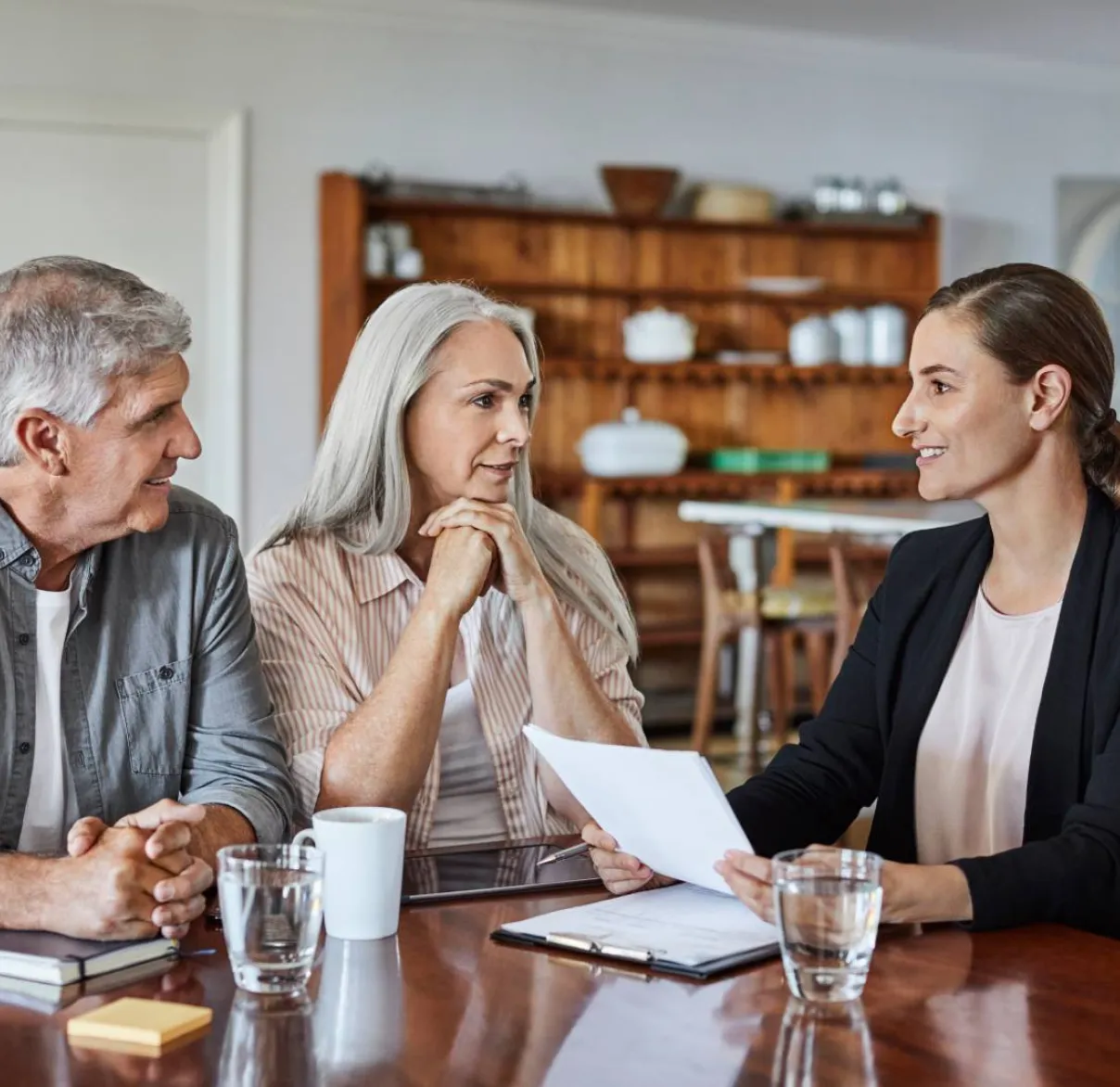 A couple meet their financial adviser at the kitchen table