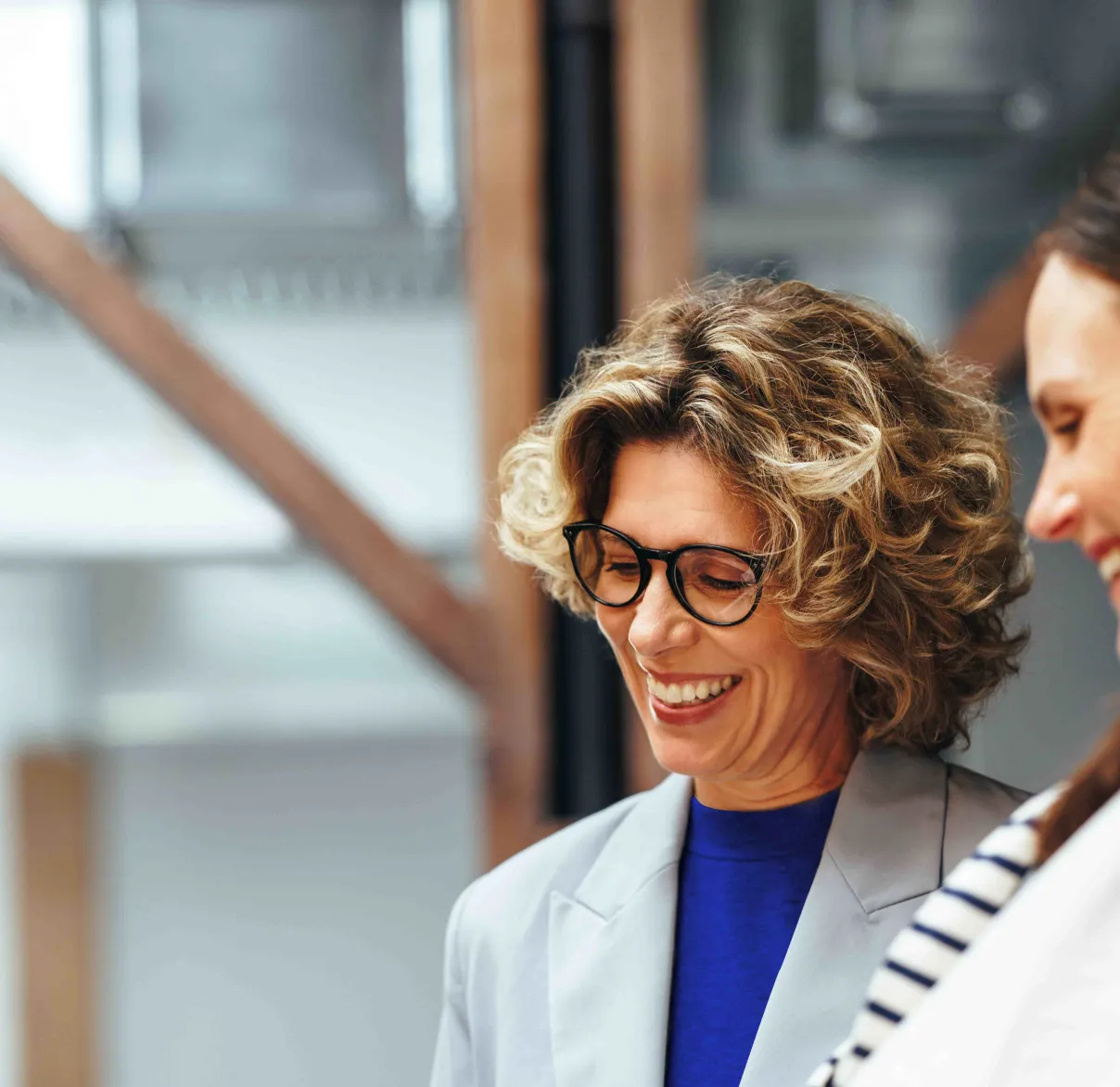 a woman working with her colleague on a tablet