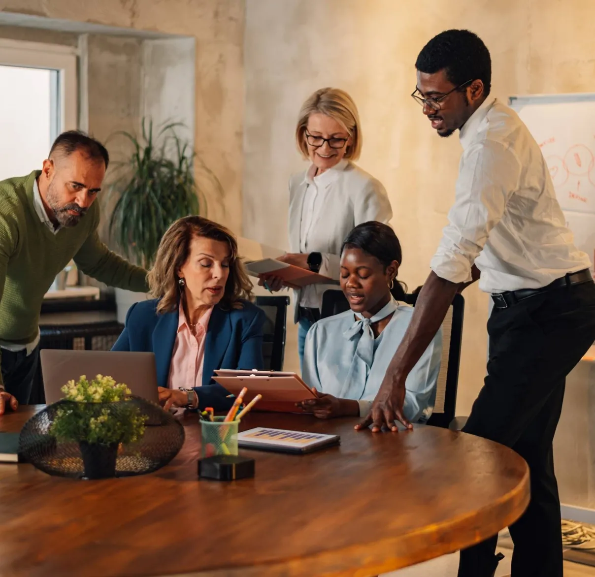 A group of financial advisers working together during a collaborative meeting