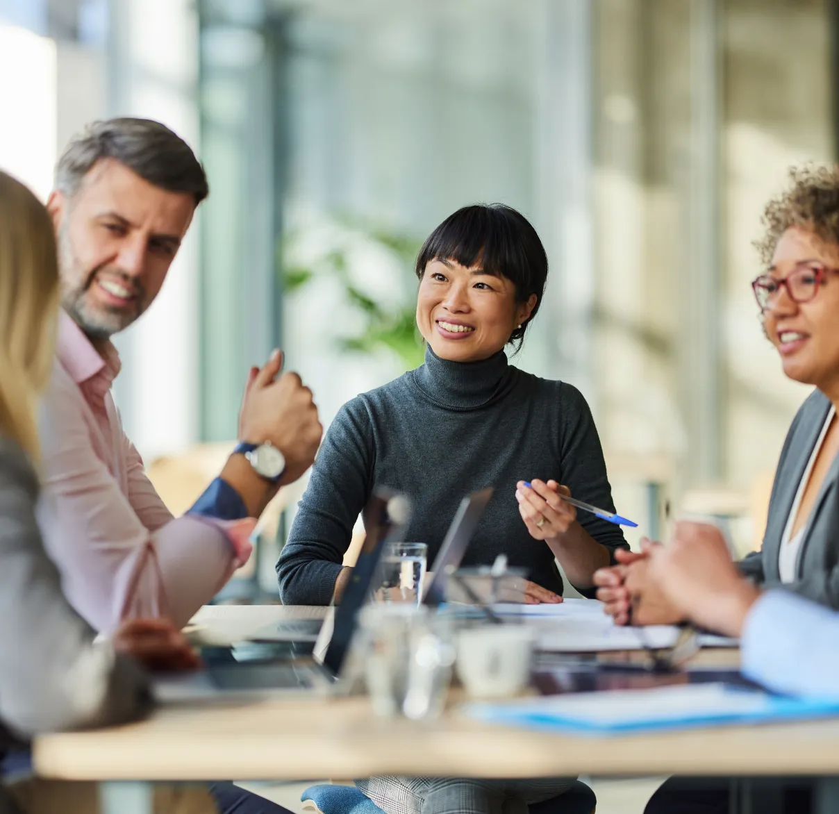 A group of colleagues meet together in the office