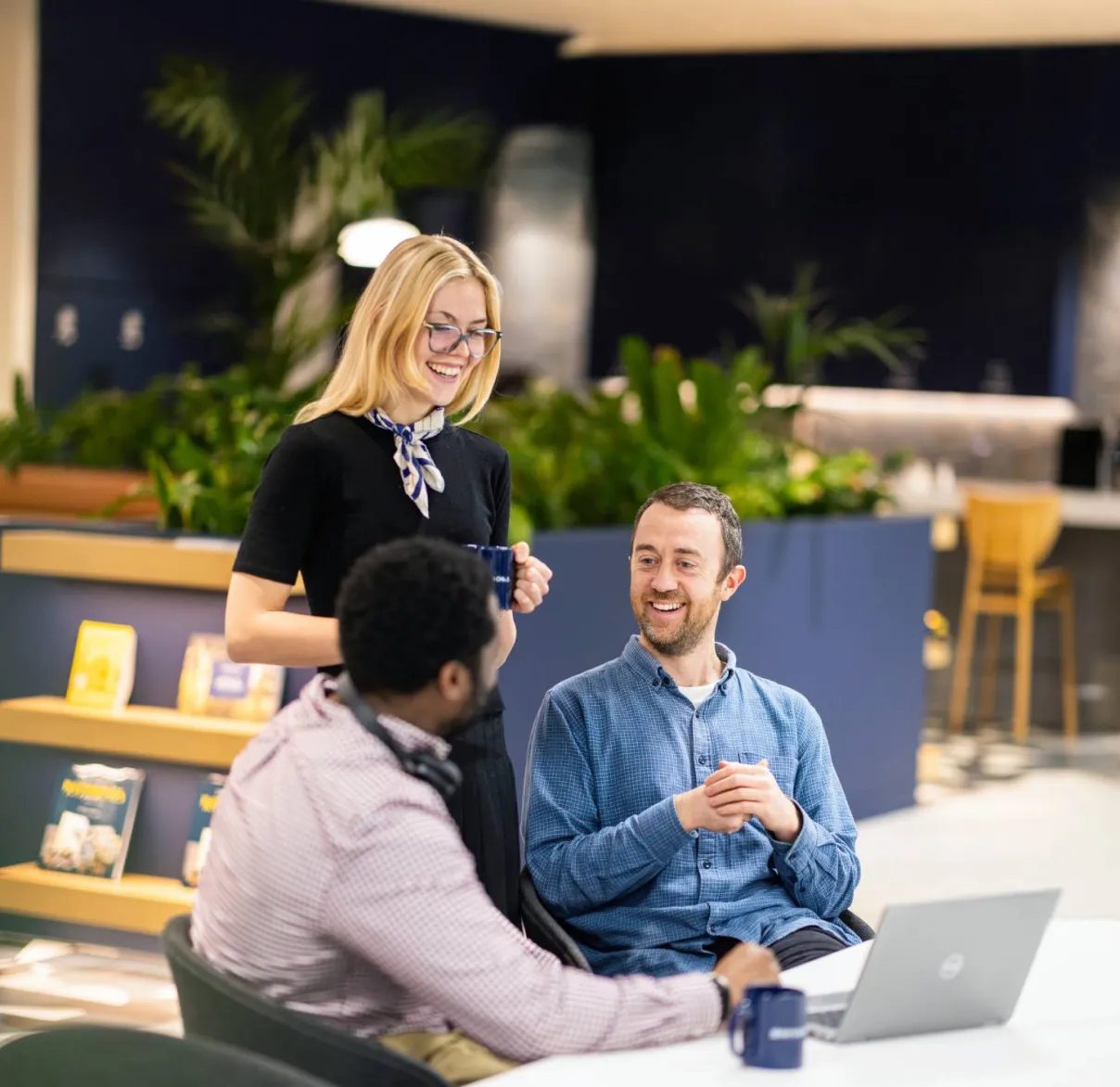 Rathbones colleagues talking in a kitchen area of the office about responsible business