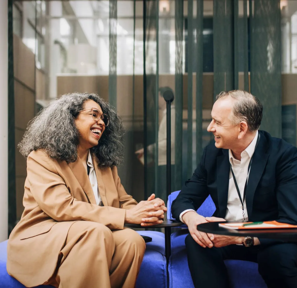 A woman laughs during a meeting with her financial planner