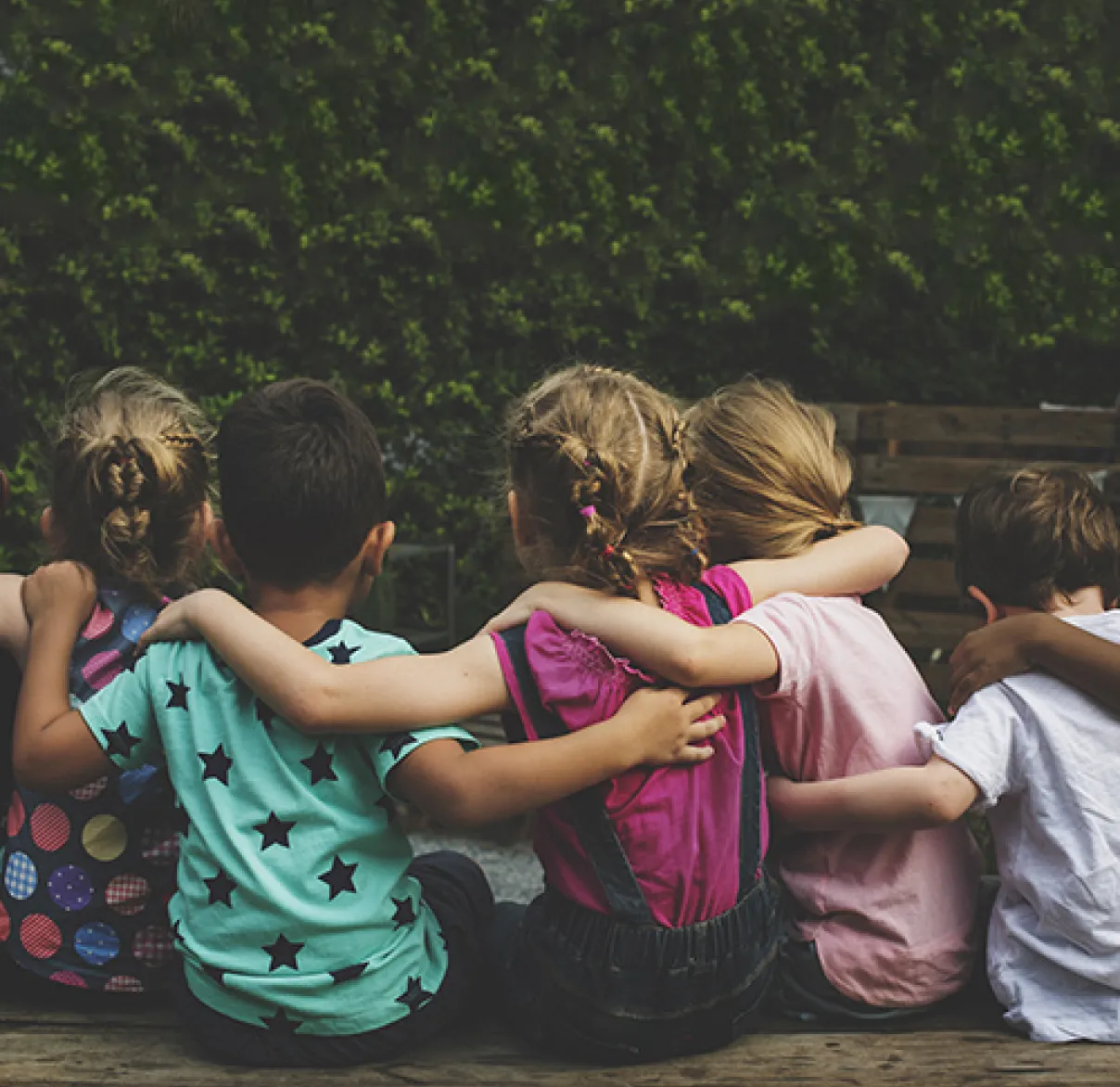 A group of children hugging together