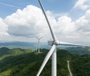 Wind turbines spinning in the wind on a hilltop