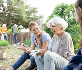 Three charity trustees sat down outside at a charity investment event