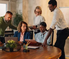 A group of corporate workers meet in a rustic conference venue