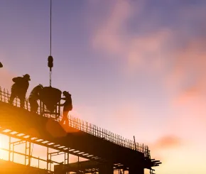 Construction workers at sunset