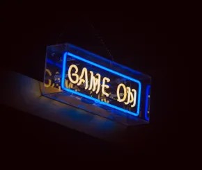 A neon light sign that says "Game on"