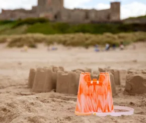 a sandcastle and bucket