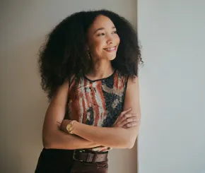 Businesswoman leaning against wall