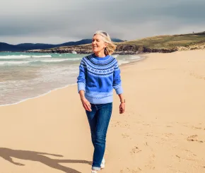 Woman walking on the beach on a beautiful sunny day