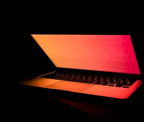 Laptop showing an orange and red gradient screen