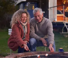 Couple roasting marshmallows by the fire