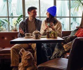 Couple in cafe with dog
