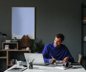 Business man working on his laptop at his modern office desk