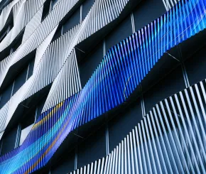 Modern architectural pattern with blue and white flowing geometric forms.