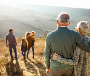 senior couple looking at their family in nature