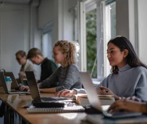 young people learning at a laptop station
