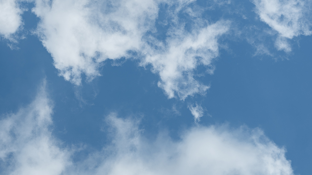 Looking skyward to a blue sky with some whispy clouds