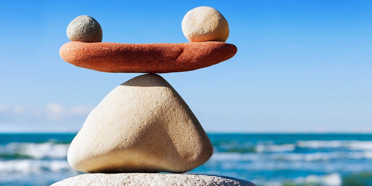 Balancing stones with waves in the background